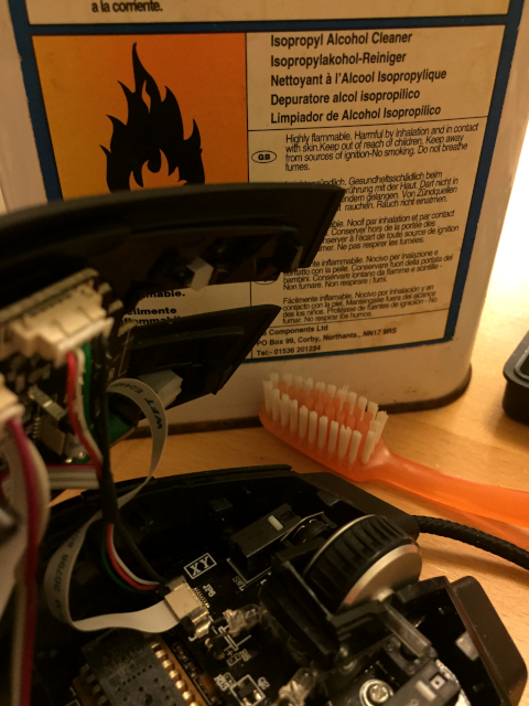 Can of Isopropyl Alcohol and disassembled Corsair M40 Raptor mouse