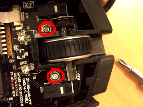 Two Philips PH1 self-tapping screws holding the button PCB board in place within the Corsair M40 Raptor mouse